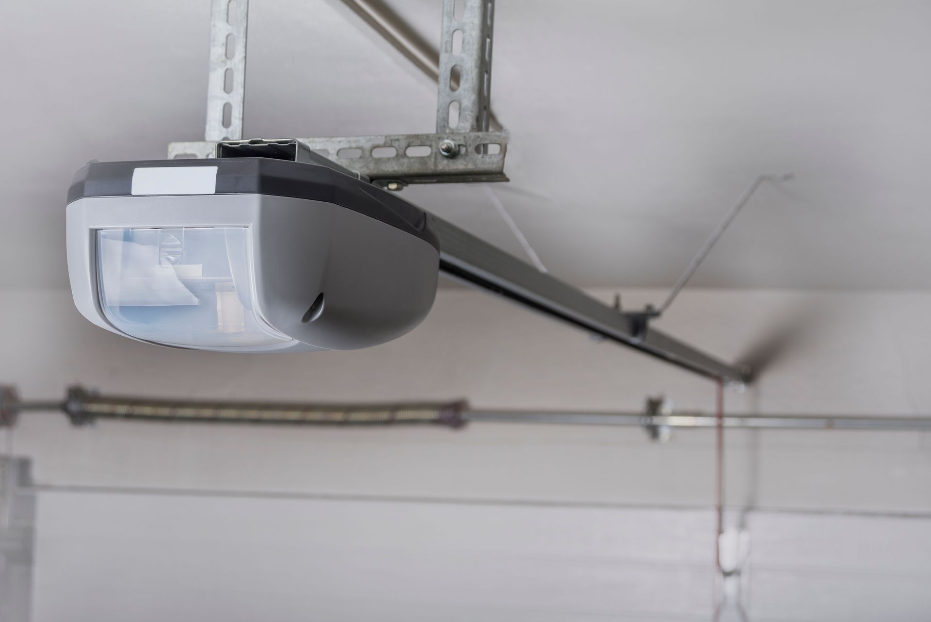 Garage door opener mounted on a white ceiling.