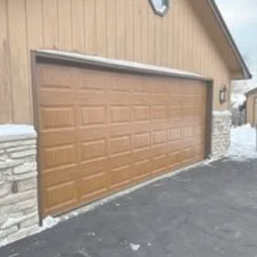 Garage door opener, black motor, attached to the ceiling; a red ladder is below.