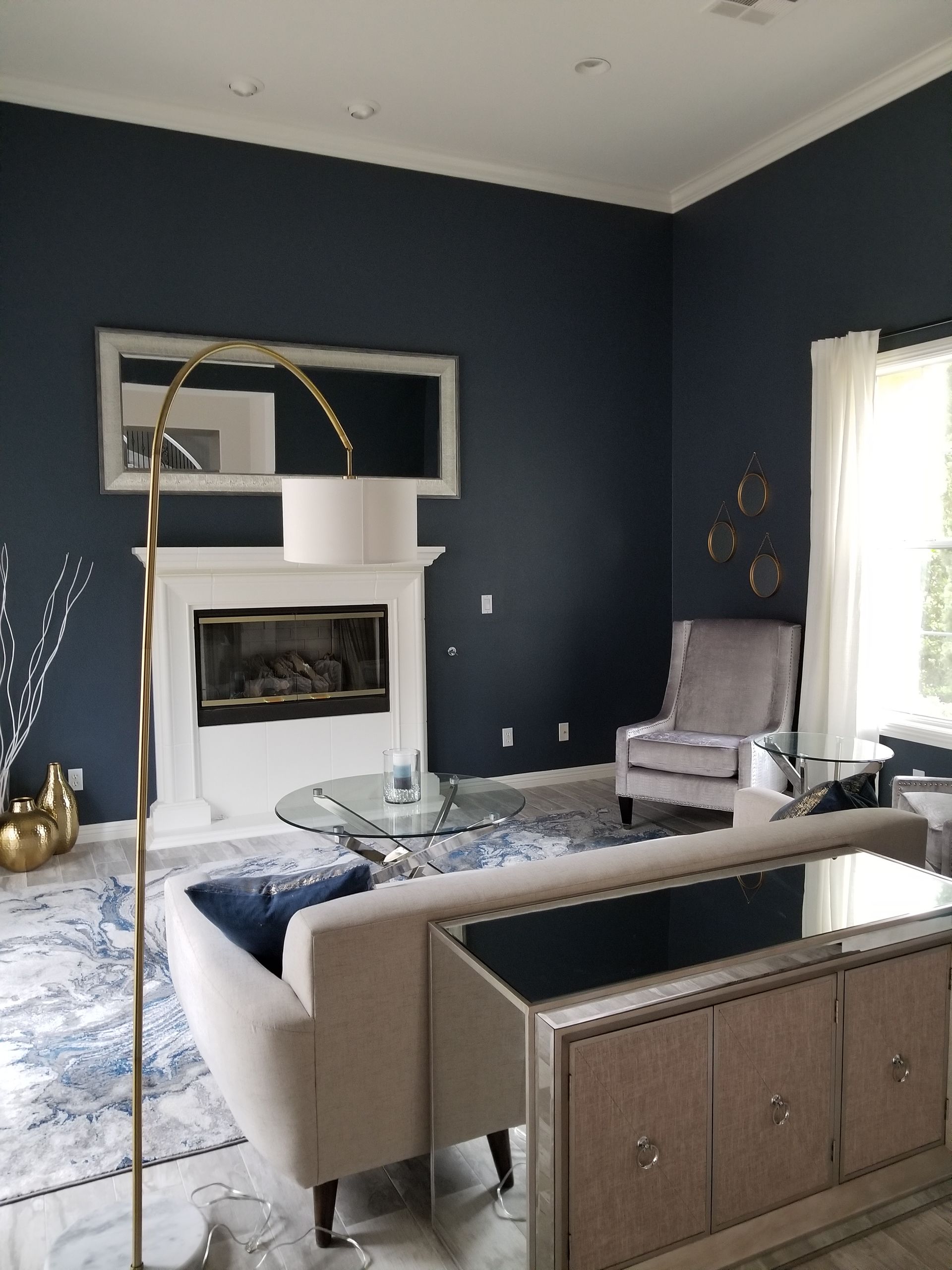 A living room with a couch a chair and a fireplace