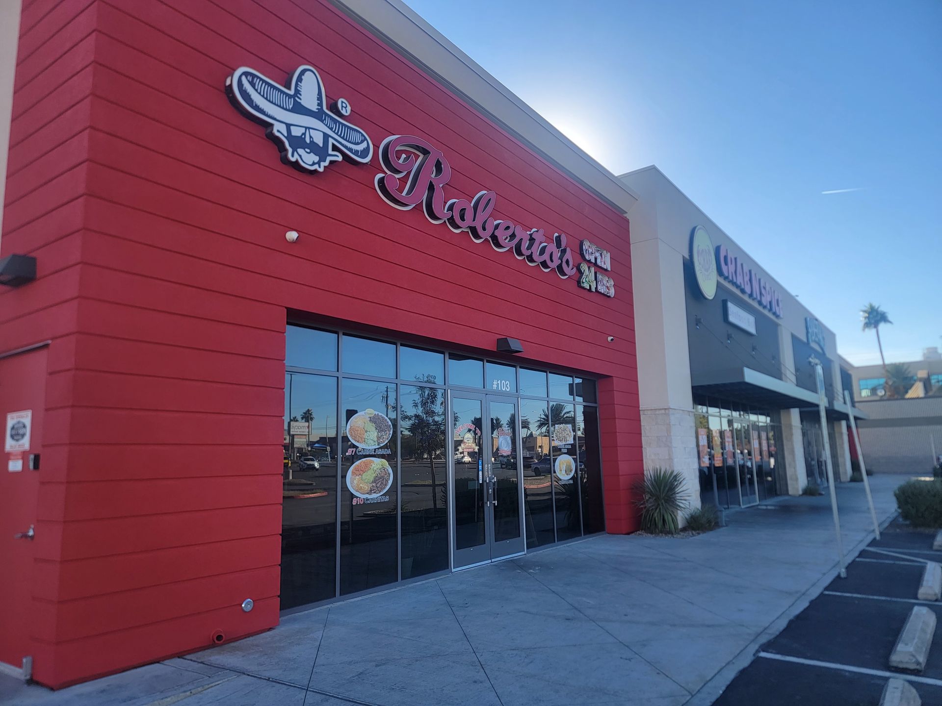 Exterior of Roberto's Mexican Food restaurant with a red facade, large windows, and signage.