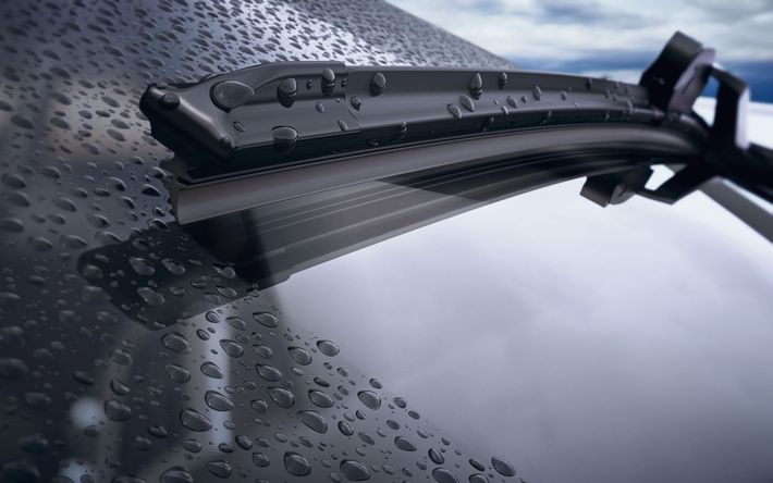 A close up of a windshield wiper on a car.