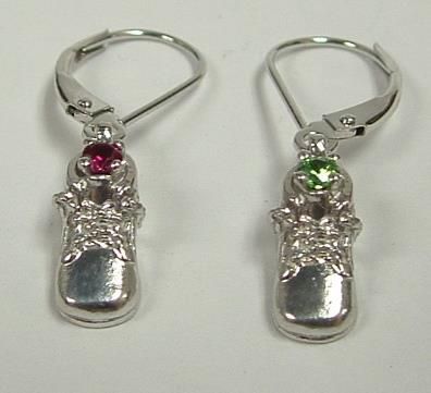 A pair of silver drop earrings, one with a red gem and the other with a green gem. Each has a floral accent.