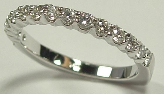 Diamond ring, a band of small, round-cut diamonds set in a silver metal band, close-up.