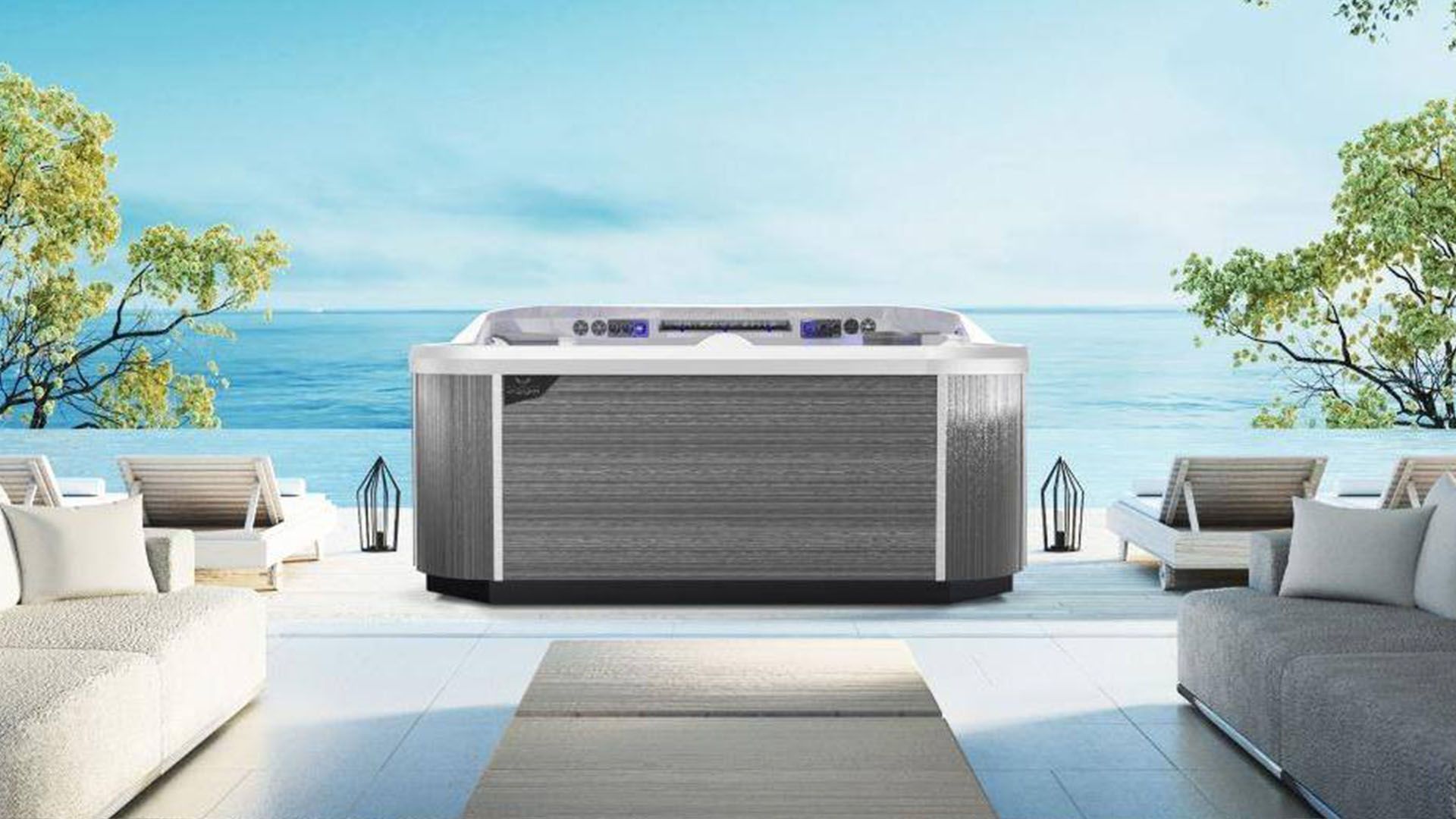 A hot tub is sitting on a patio overlooking the ocean.