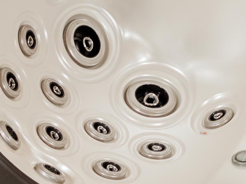 A close up of a hot tub with lots of jets