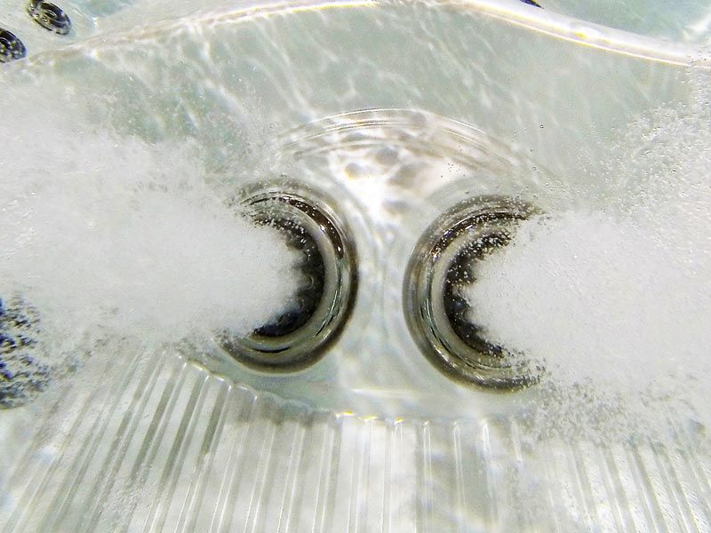 A close up of a hot tub with bubbles coming out of it.