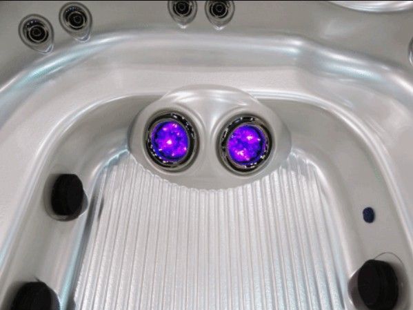 A close up of a hot tub with purple lights on it.