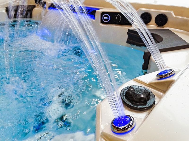 A hot tub with a waterfall coming out of it