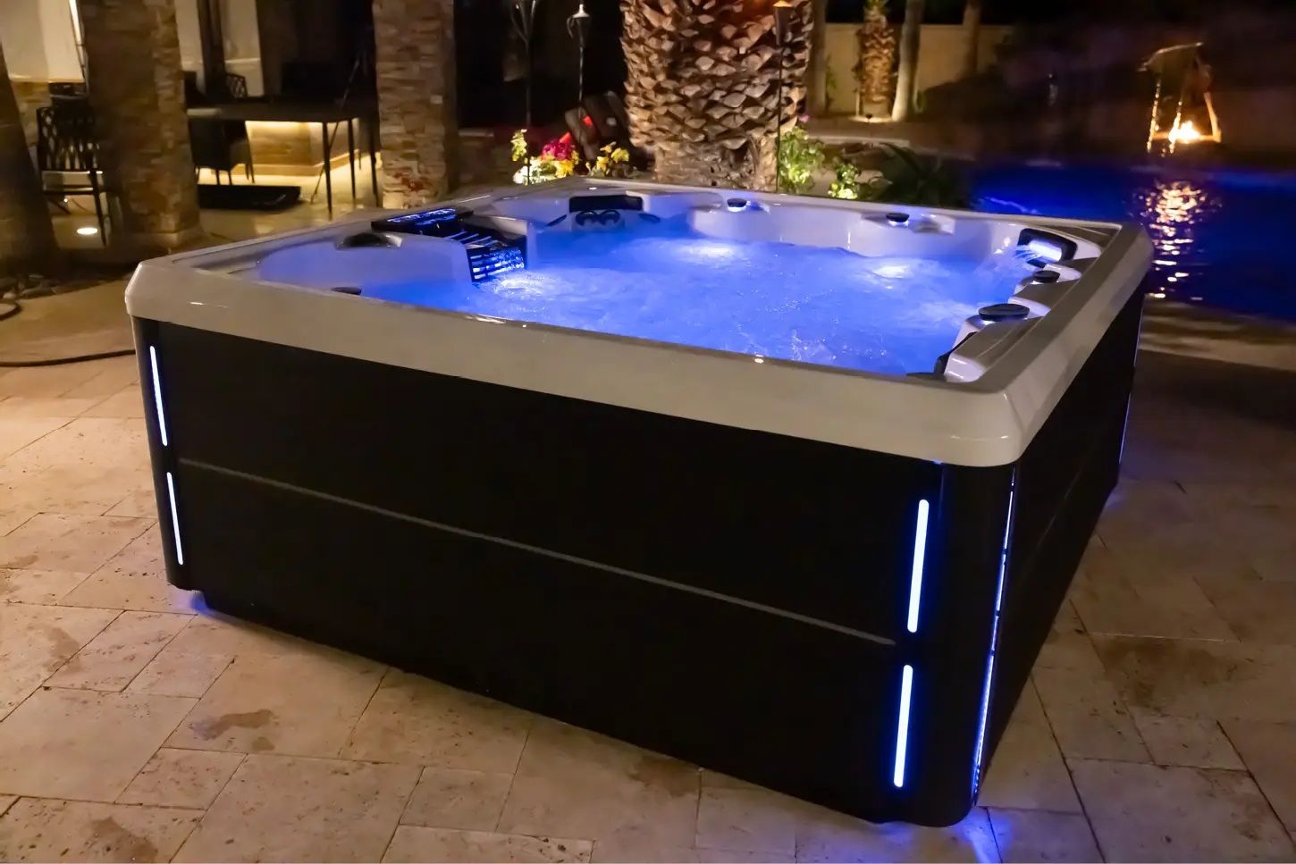 A black and white hot tub with blue lights on it