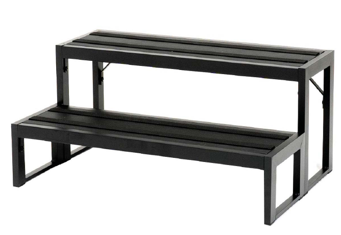 A black metal bench with two shelves on a white background.