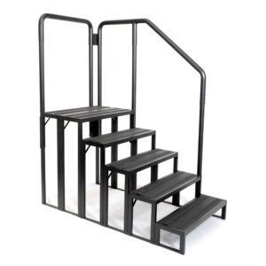 A set of stairs with a metal railing on a white background.
