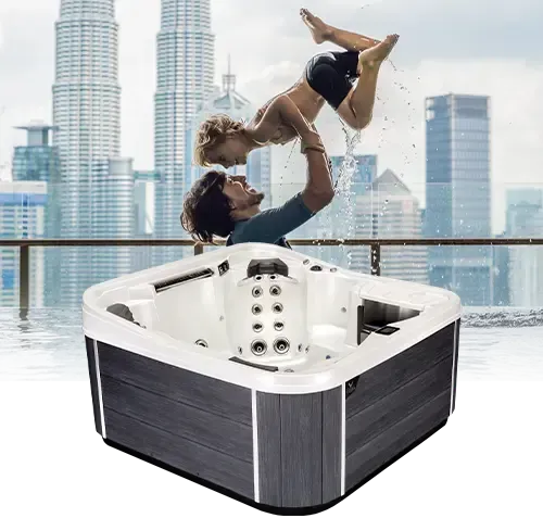 A man is holding a woman up in the air in a hot tub.
