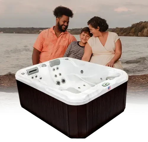 A family is standing around a hot tub on the beach.
