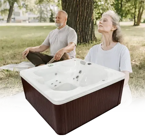 A man and a woman are sitting next to a hot tub in a park