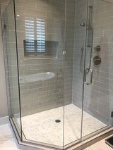 A bathroom with a walk in shower and a bathtub.
