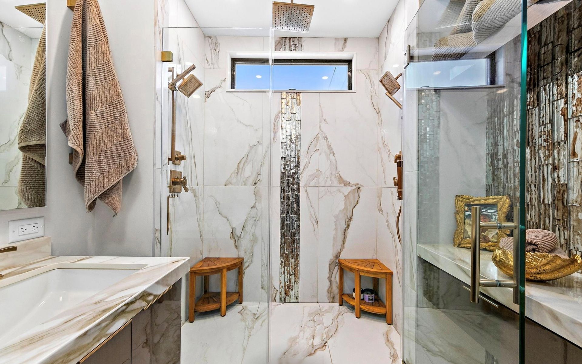 A bathroom with a walk in shower and a sink.