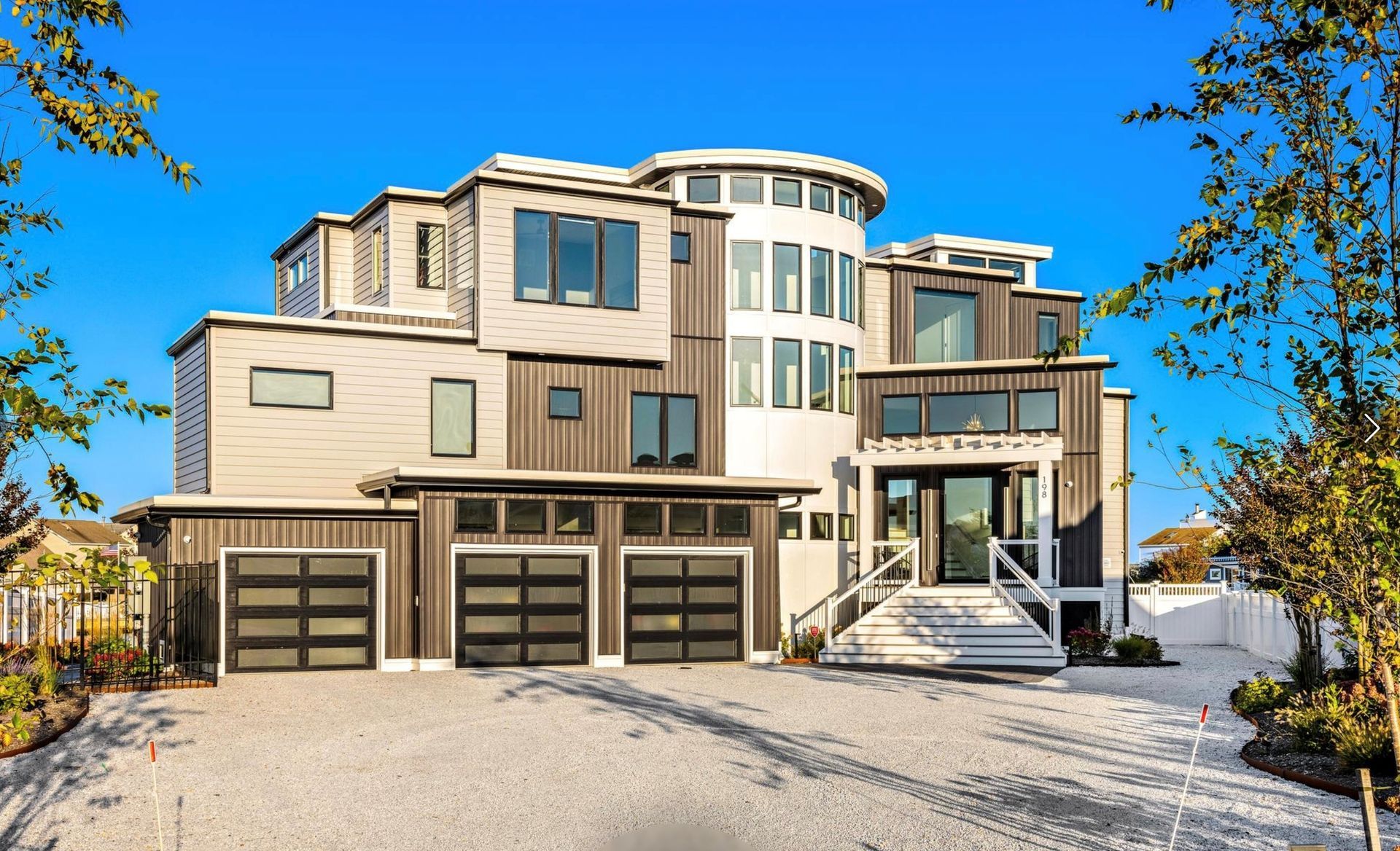 A large house with a lot of windows and a driveway.