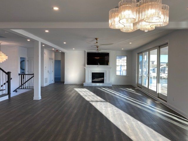 A living room with a fireplace and lots of windows