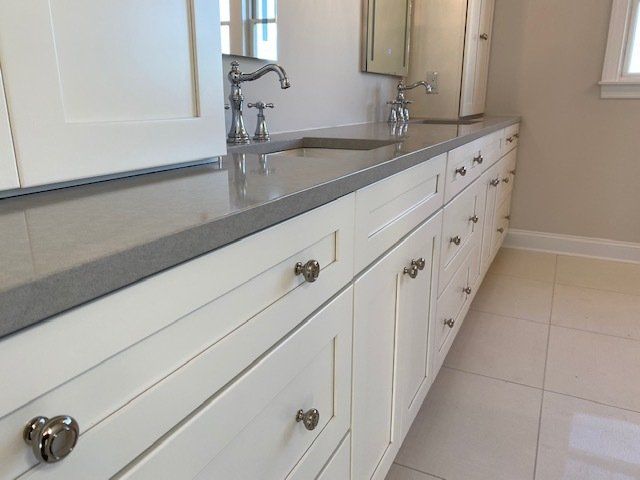 A bathroom with two sinks and a mirror