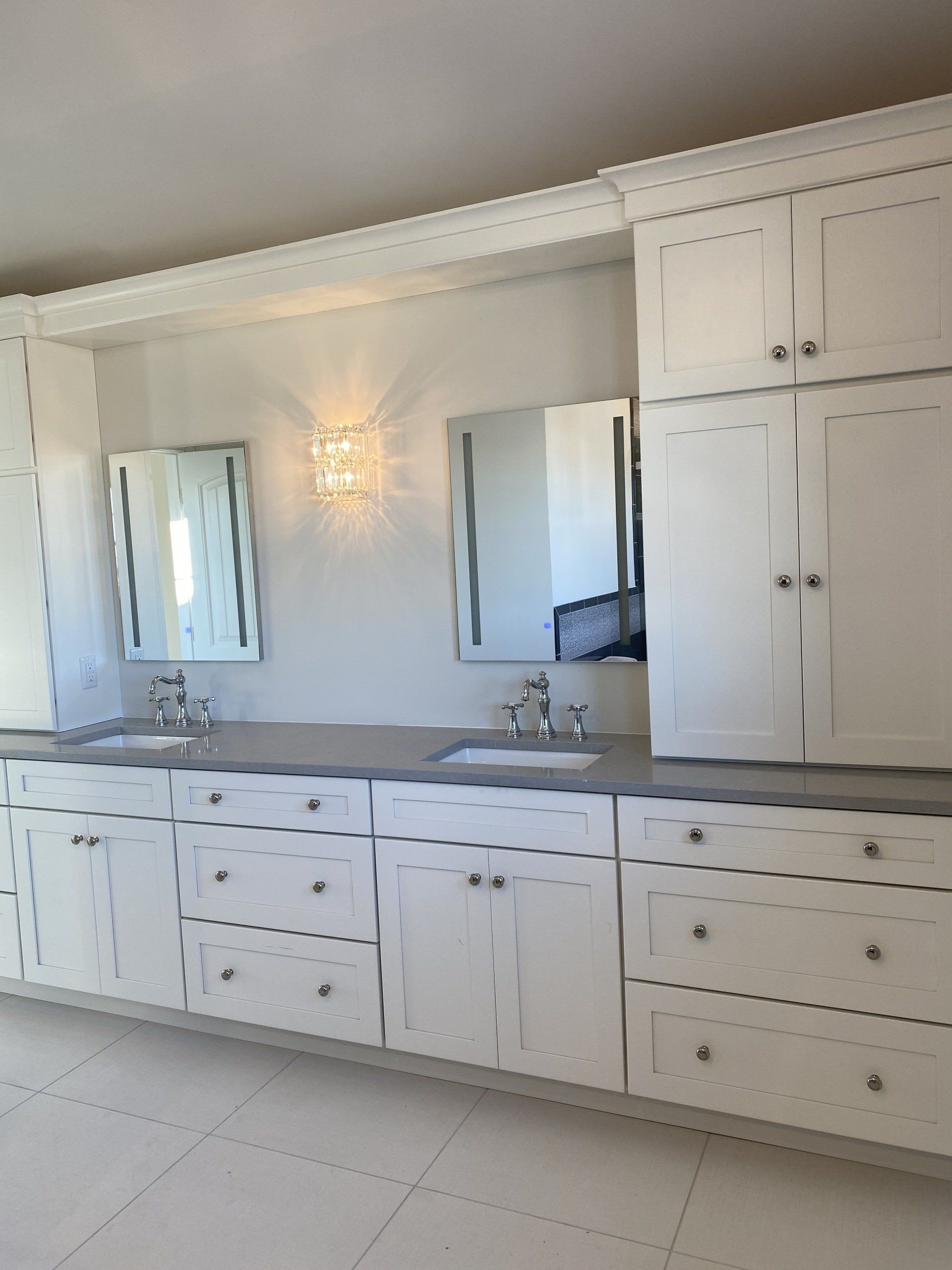 A bathroom with two sinks and two mirrors