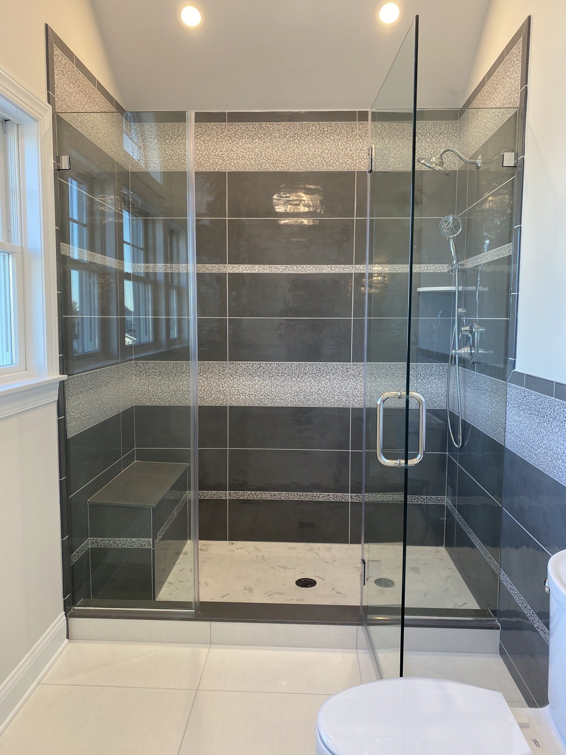 A bathroom with a walk in shower and a toilet