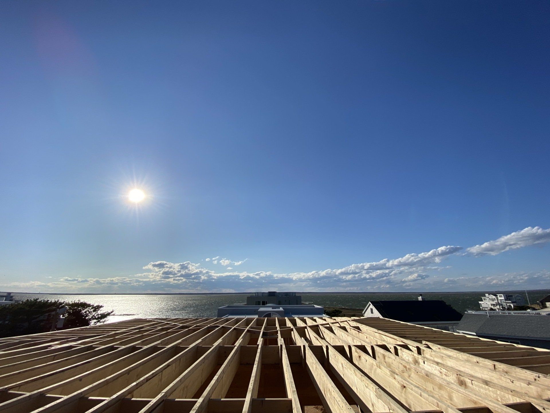A roof under construction with a view of the ocean.