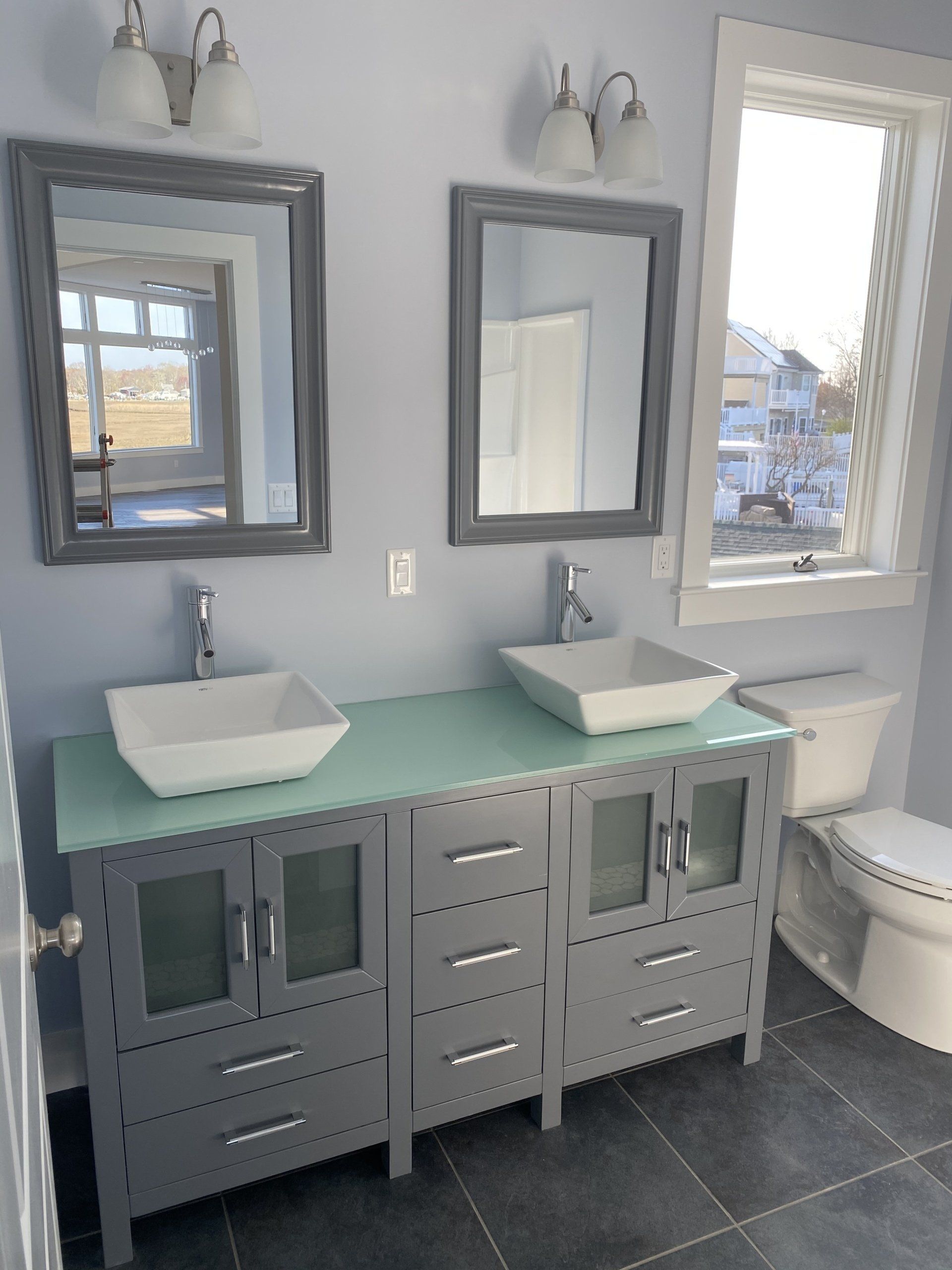A bathroom with two sinks and two mirrors