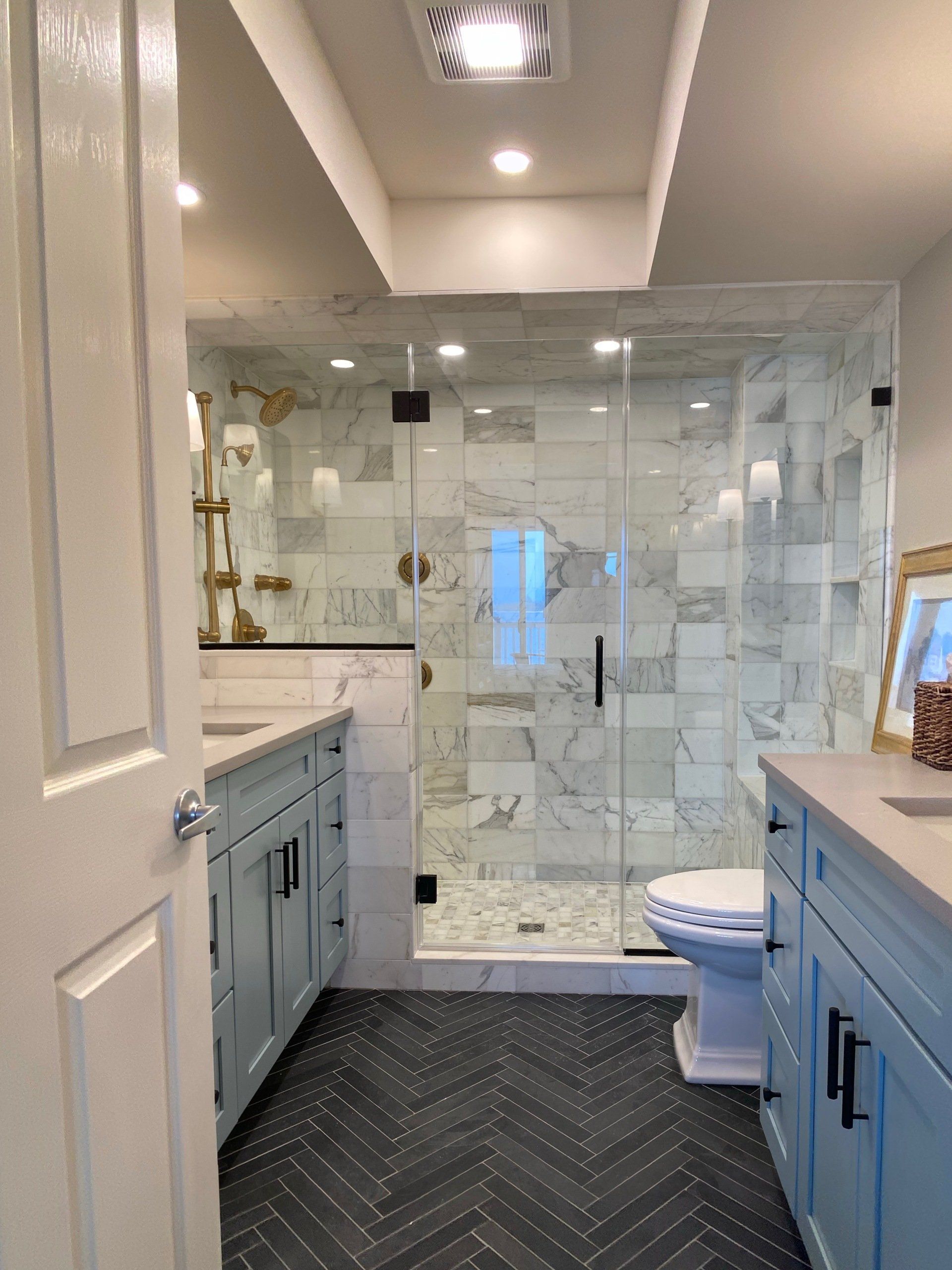 A bathroom with a toilet , sink , and shower.