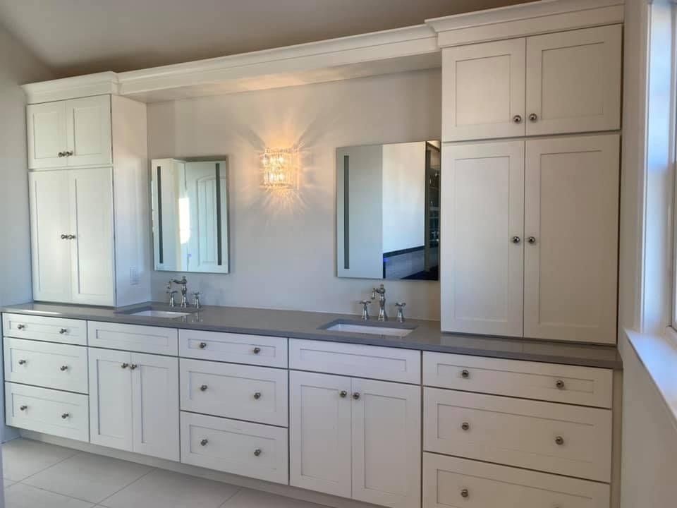 A bathroom with two sinks and two mirrors