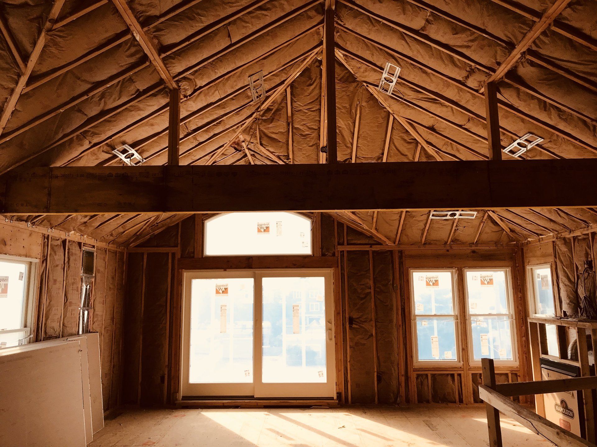 A room with a lot of windows and a wooden ceiling.