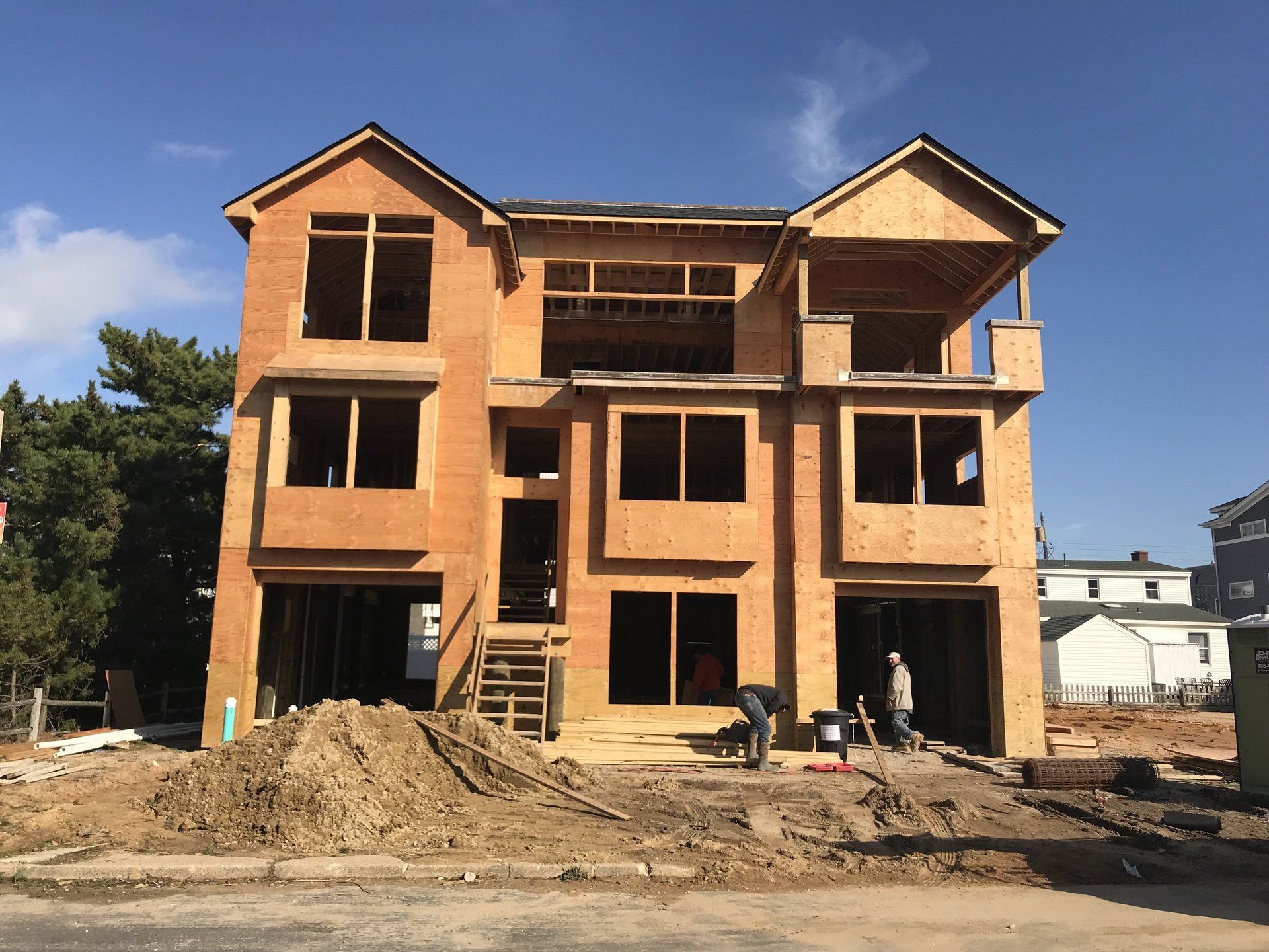 A house that is being built with a lot of windows