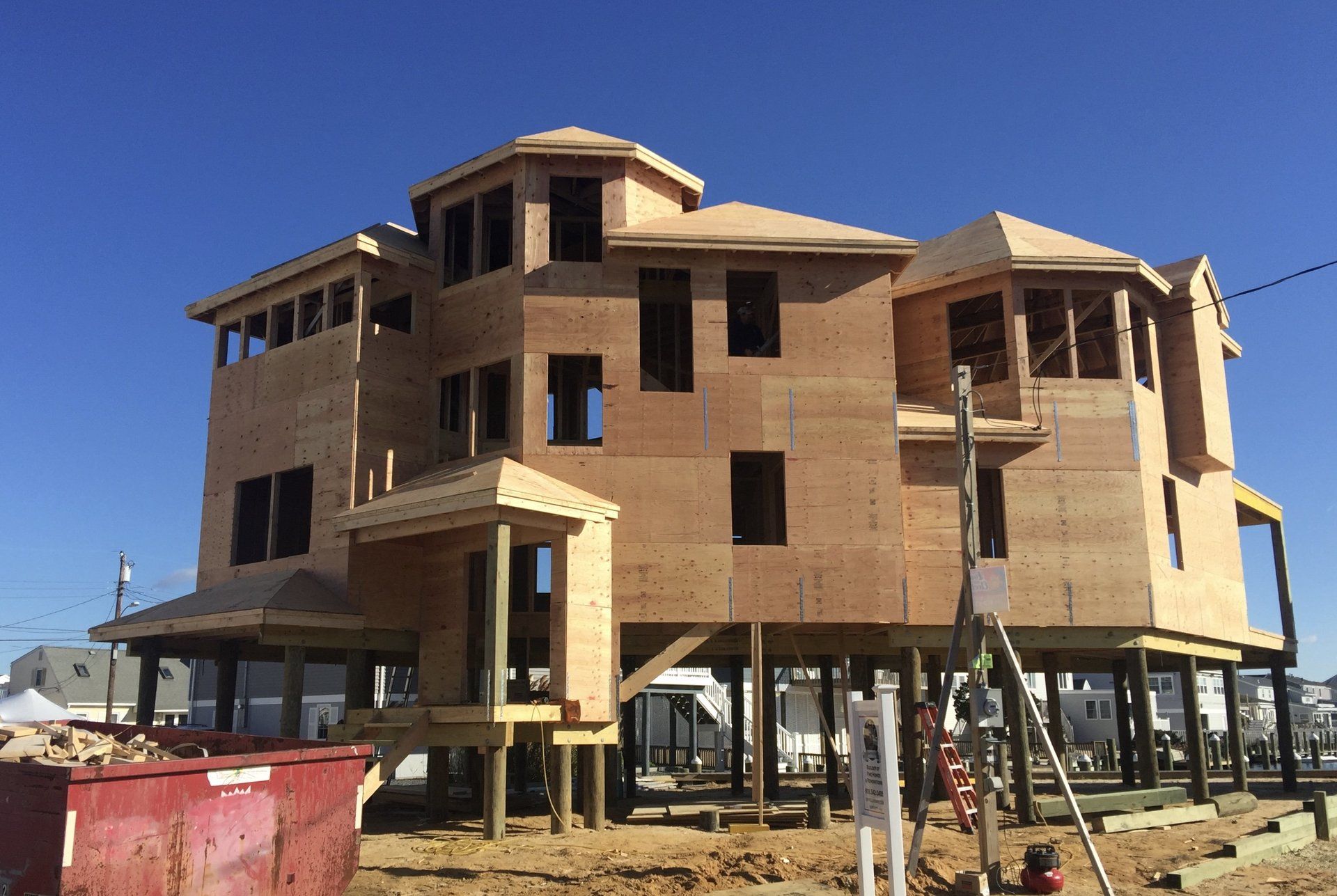 A large wooden house is being built on stilts