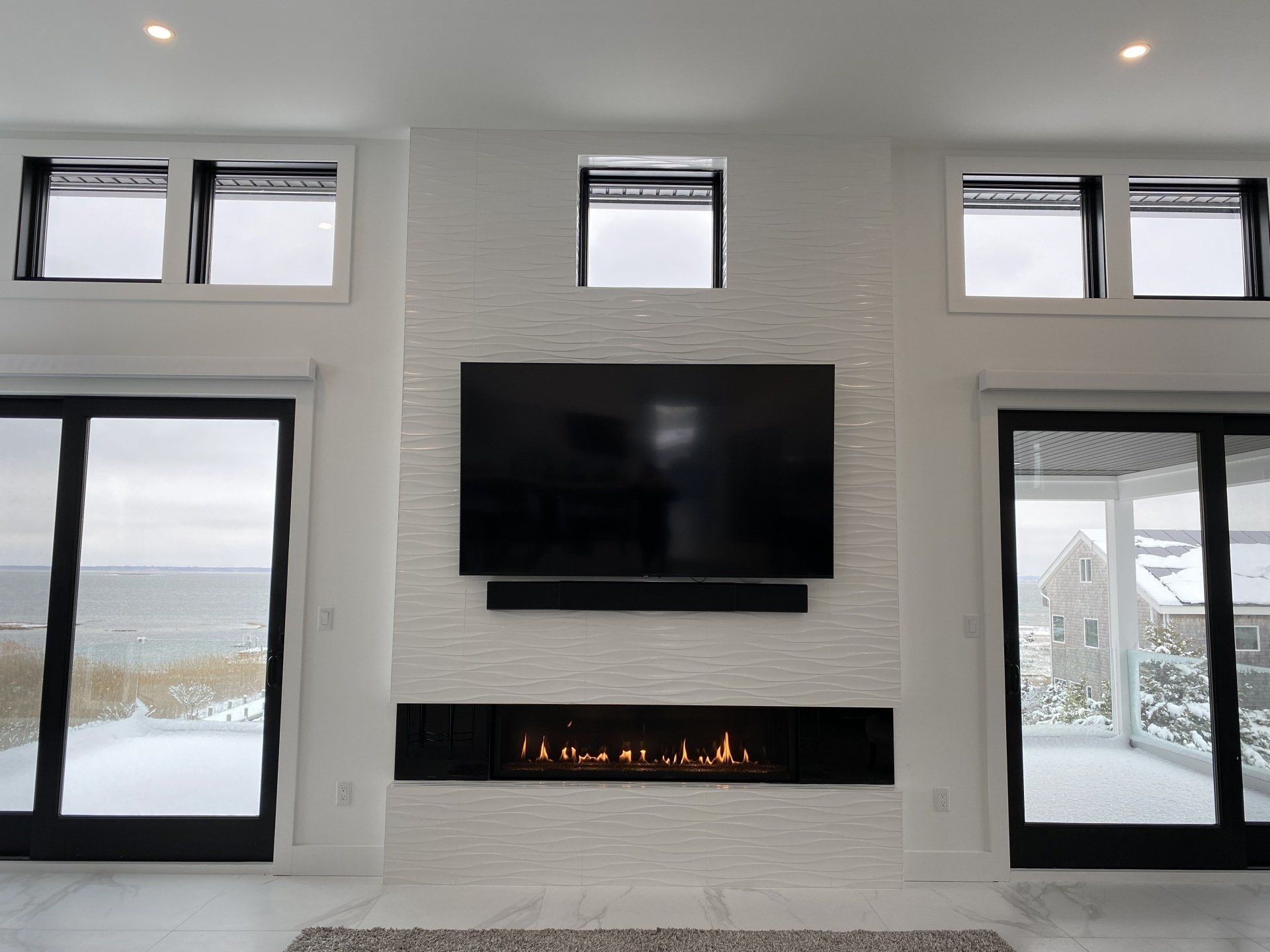 A living room with a fireplace and a flat screen tv