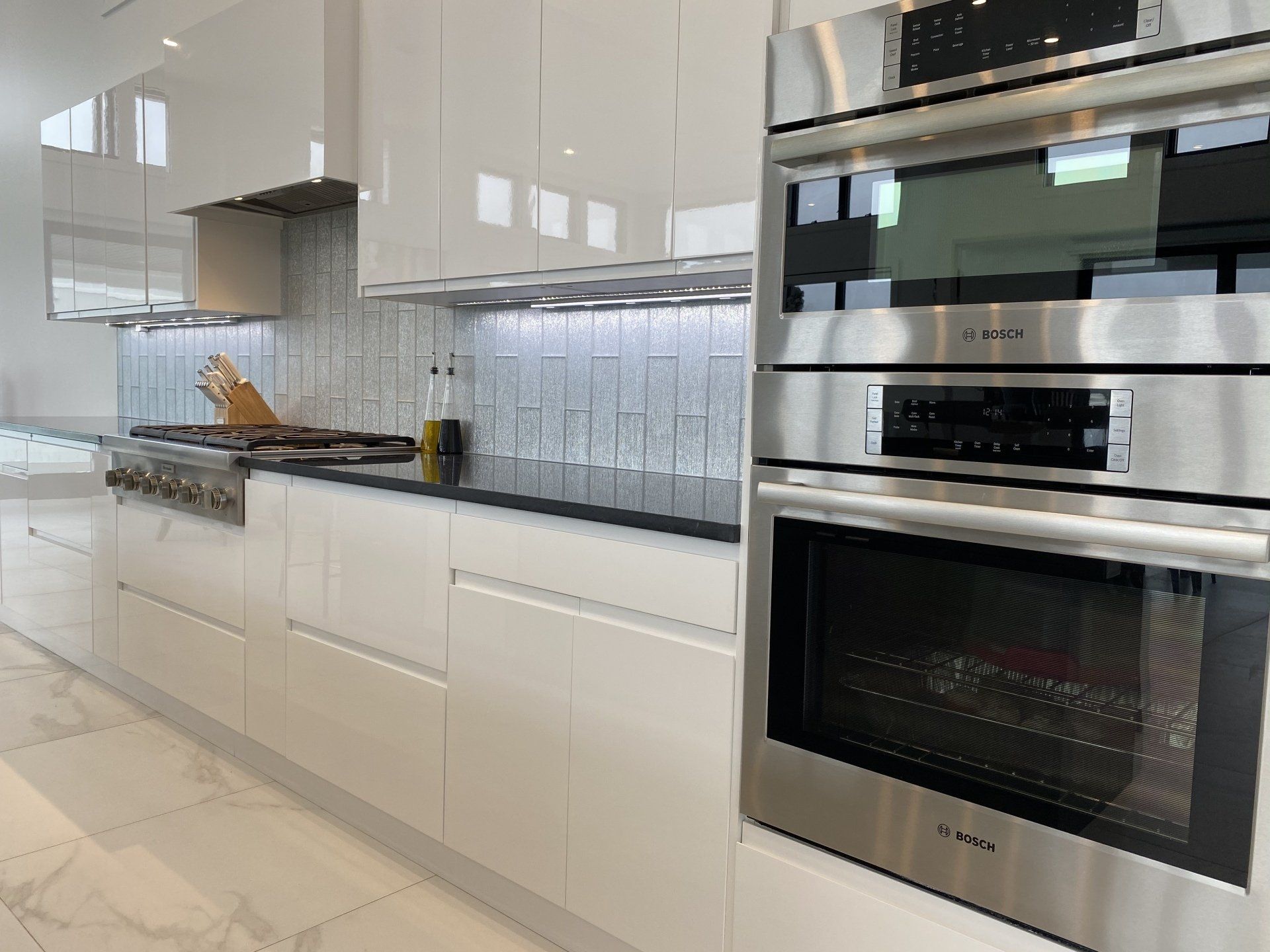A kitchen with white cabinets and stainless steel appliances.