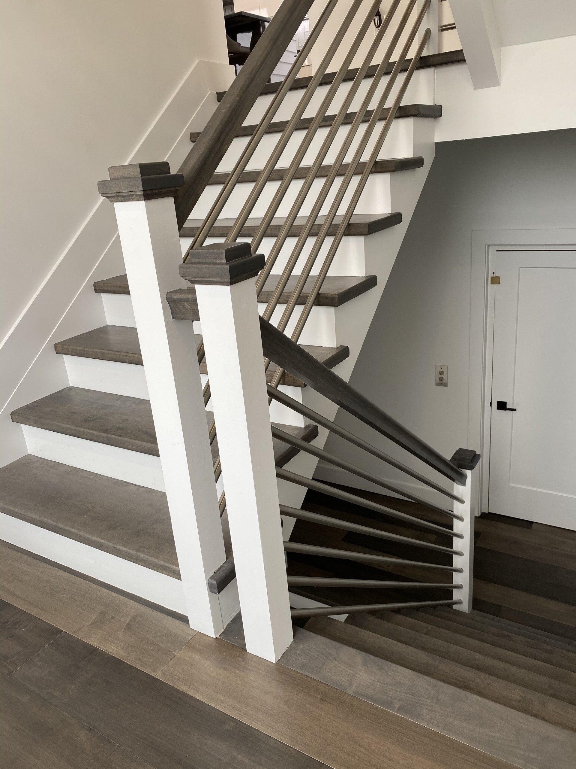 A staircase with wooden steps and a white railing