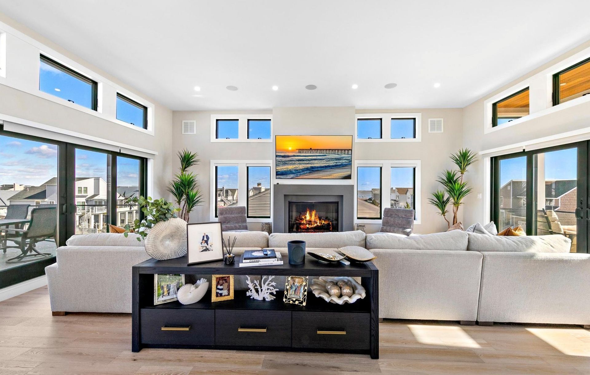 A living room with a fireplace and lots of windows