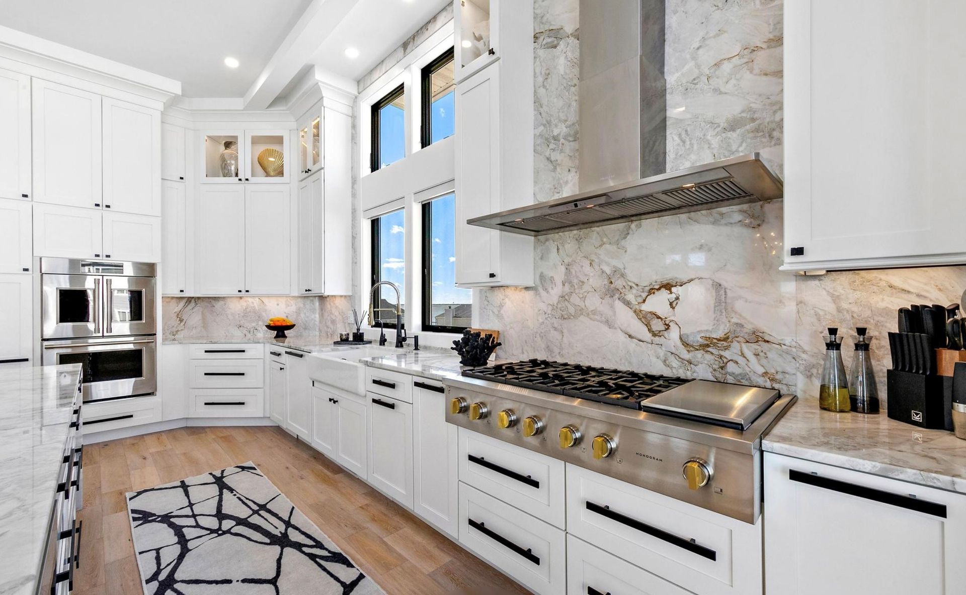 A kitchen with white cabinets and stainless steel appliances.