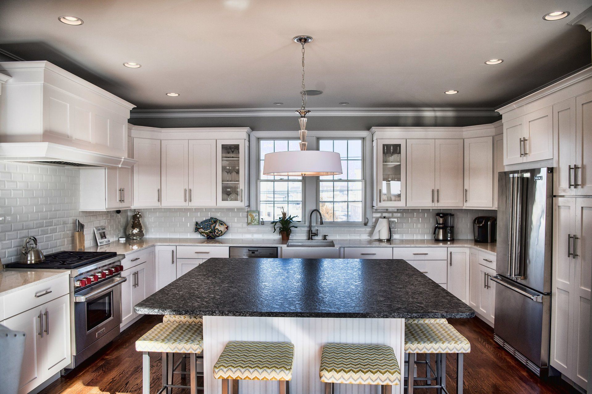 A kitchen with white cabinets and stainless steel appliances