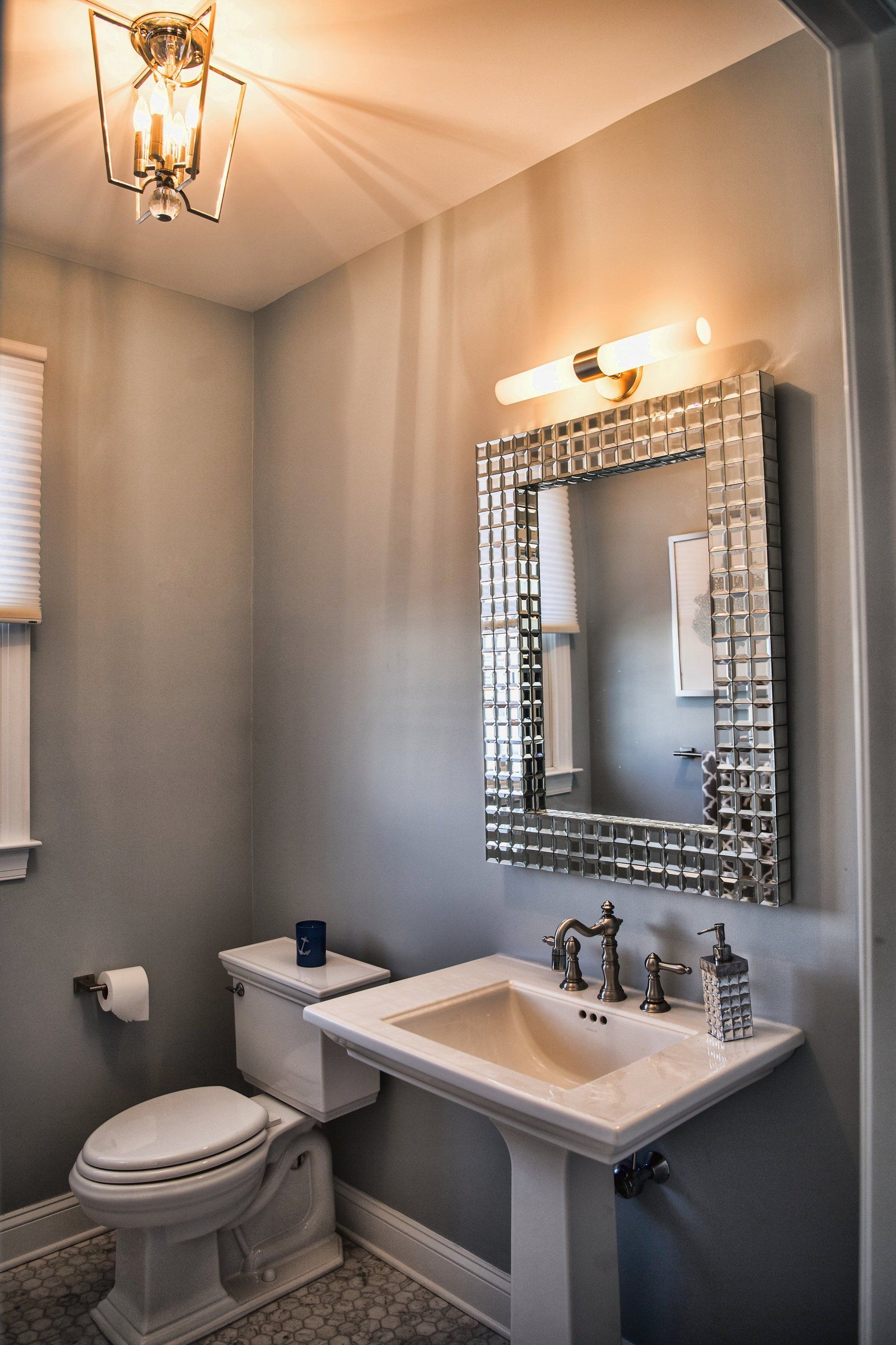 A bathroom with a toilet , sink and mirror