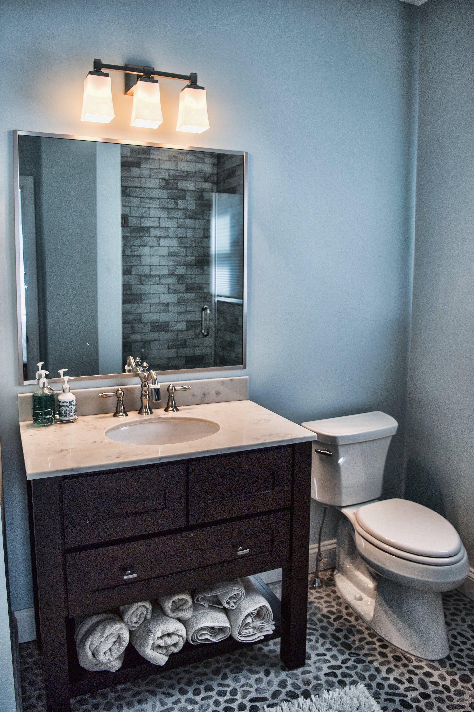 A bathroom with a sink , toilet and mirror