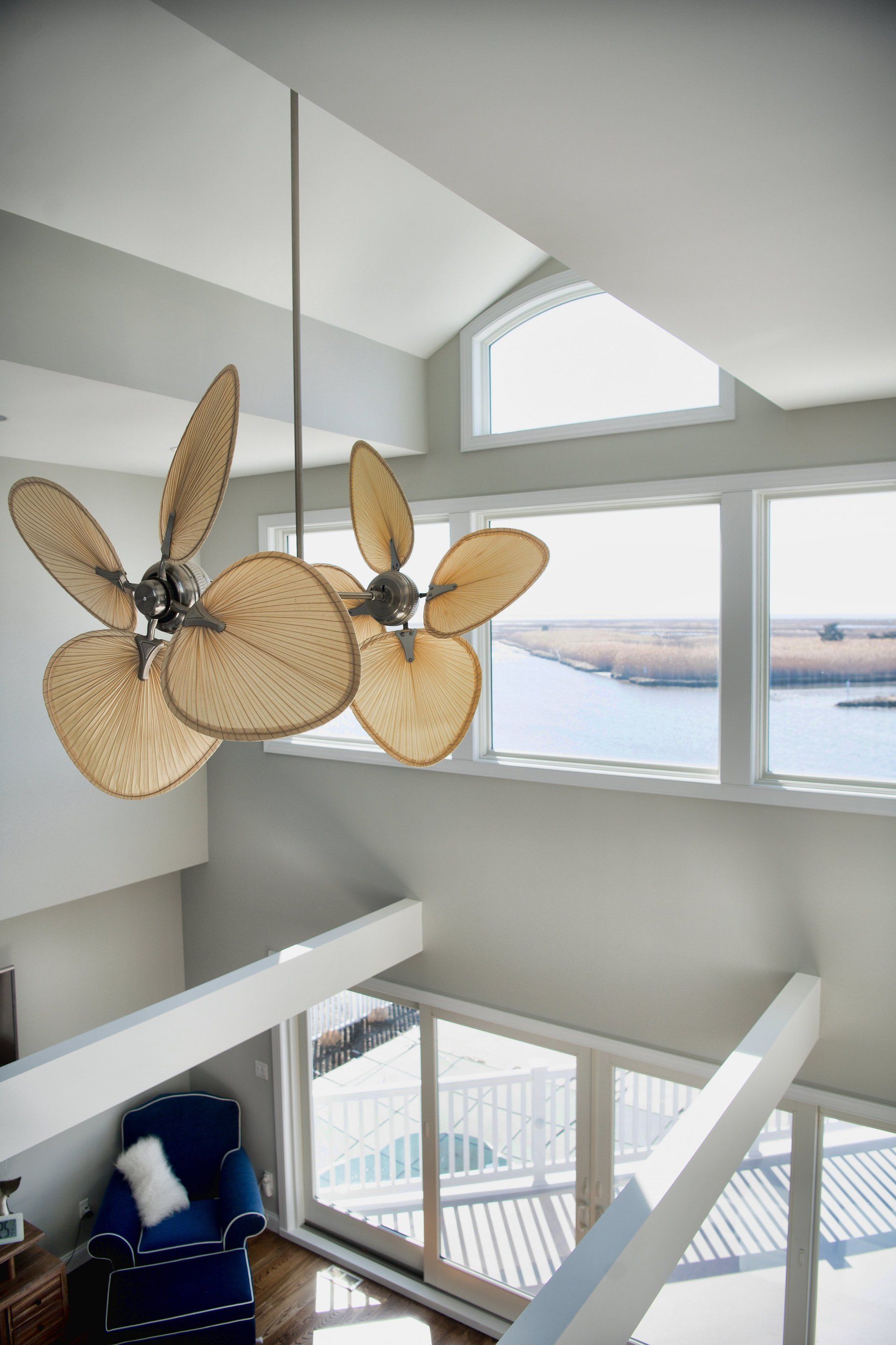 A living room with a ceiling fan hanging from the ceiling