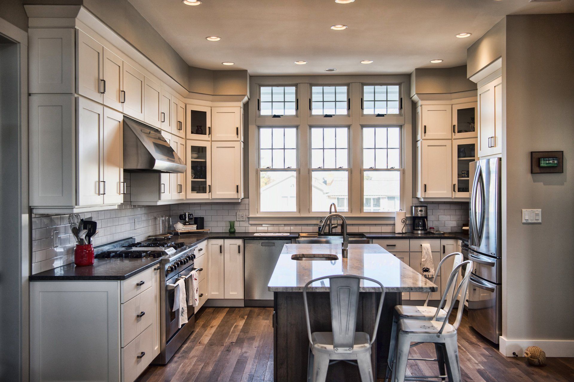 A kitchen with white cabinets and stainless steel appliances