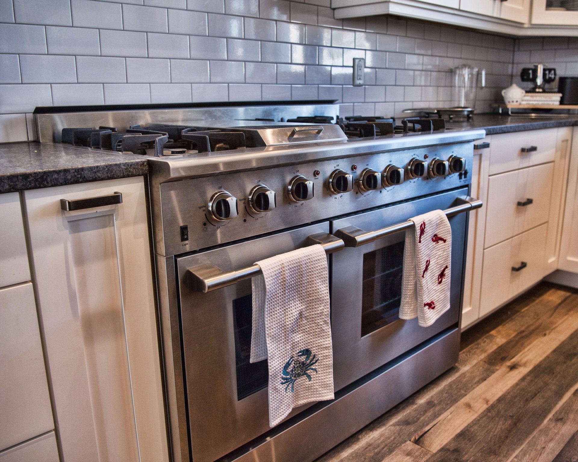 A kitchen with a stainless steel stove top oven