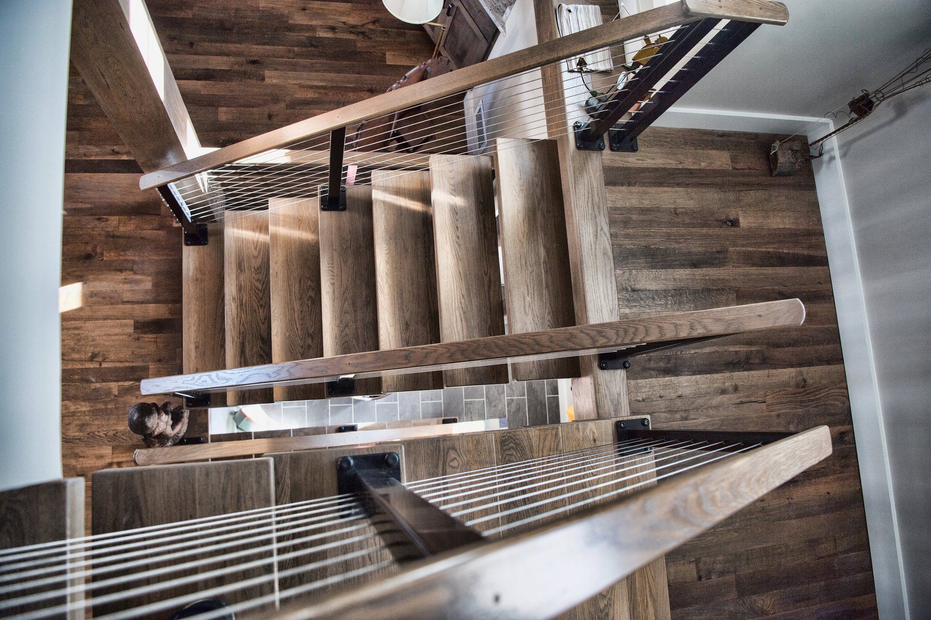 The stairs are made of wood and metal and have a metal railing.