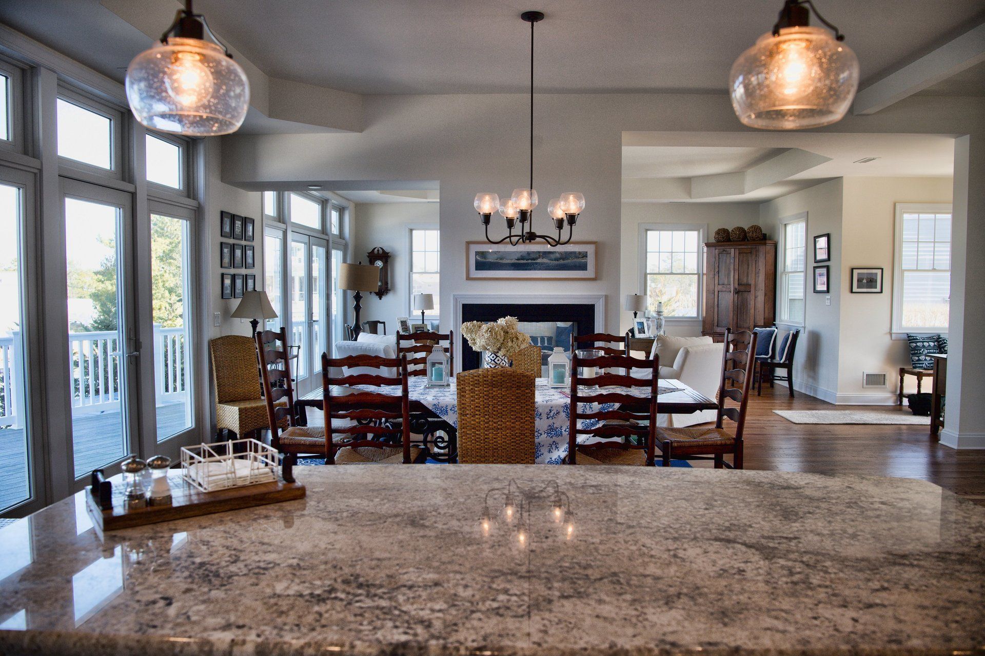 A kitchen with a granite counter top and a chandelier hanging from the ceiling
