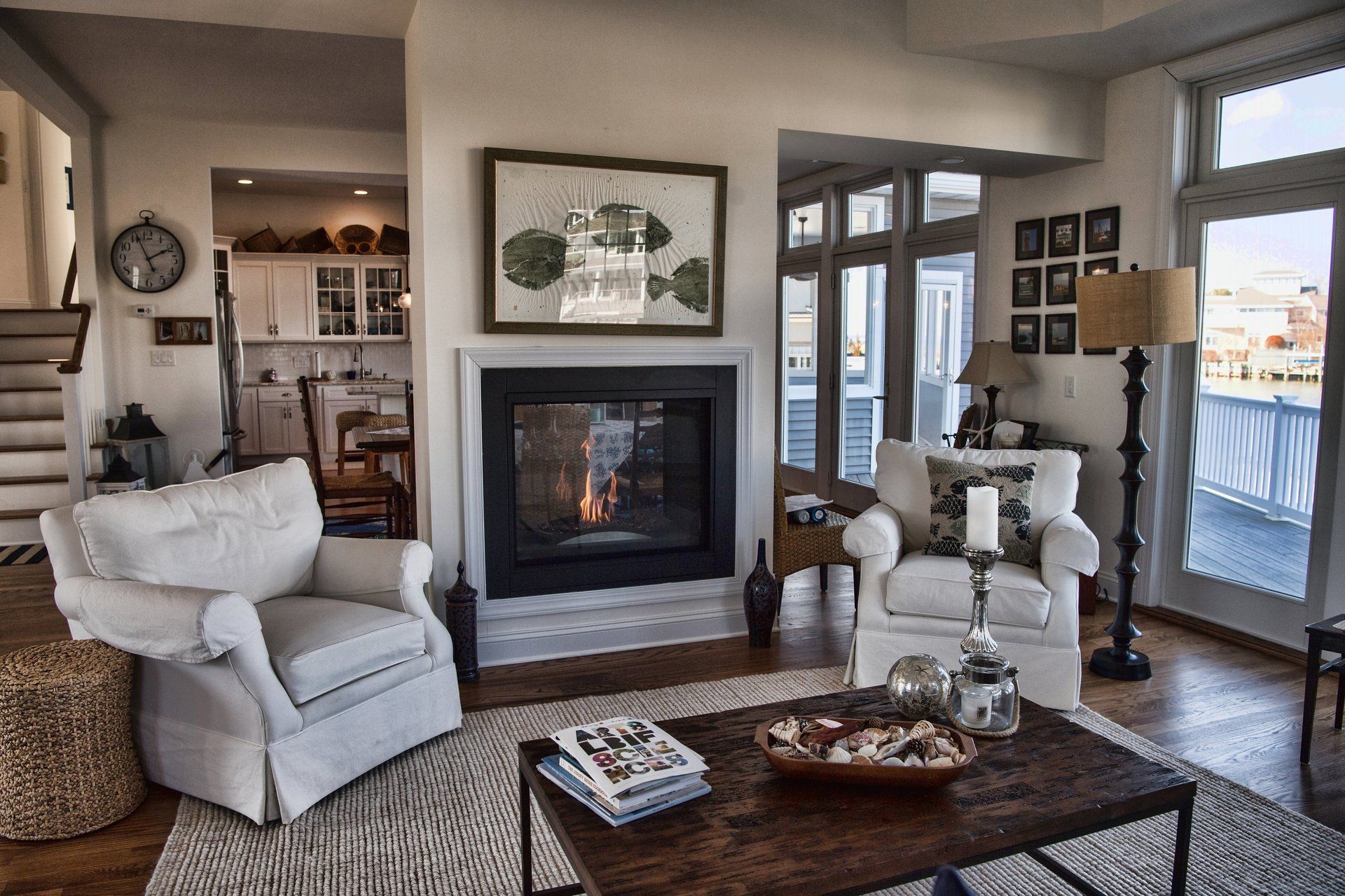 A living room with white furniture and a fireplace
