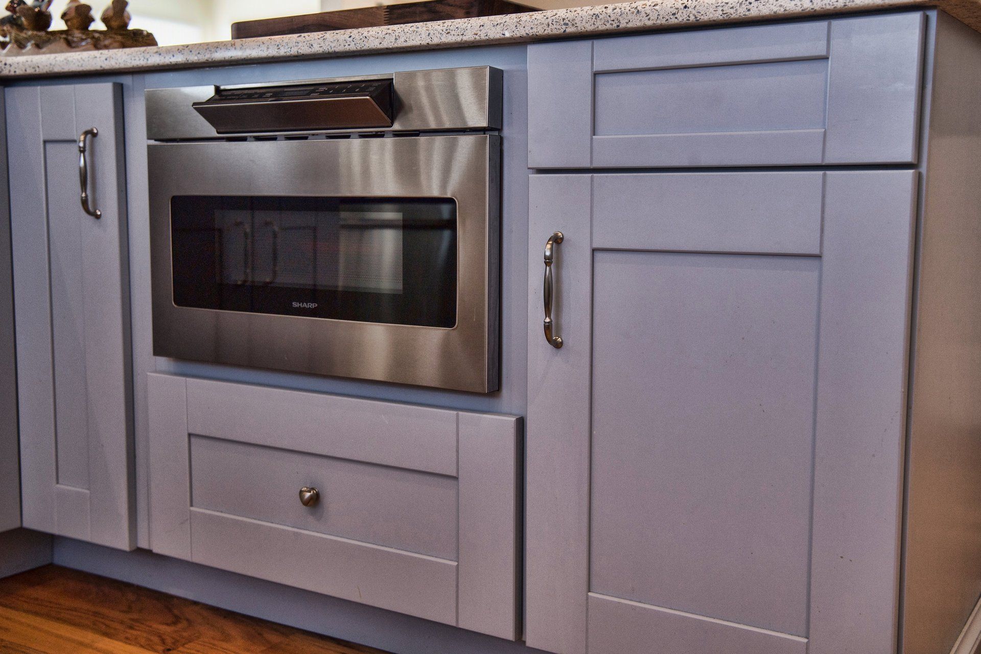 A kitchen with stainless steel appliances including a microwave oven