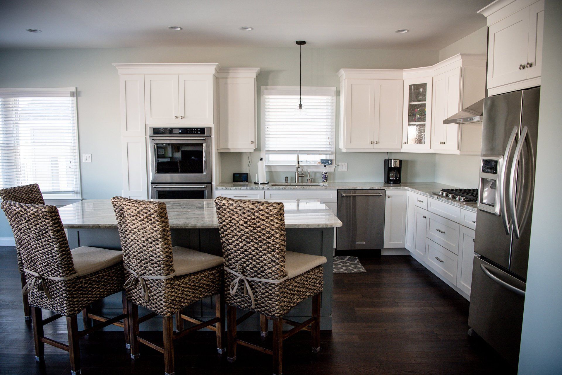 A kitchen with white cabinets and stainless steel appliances