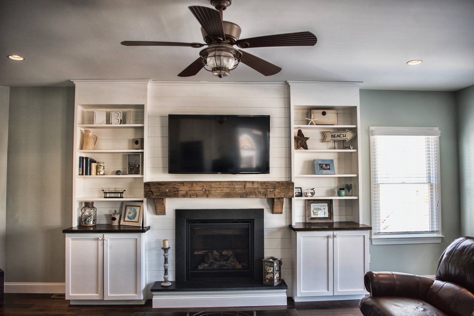 A living room with a fireplace and a flat screen tv