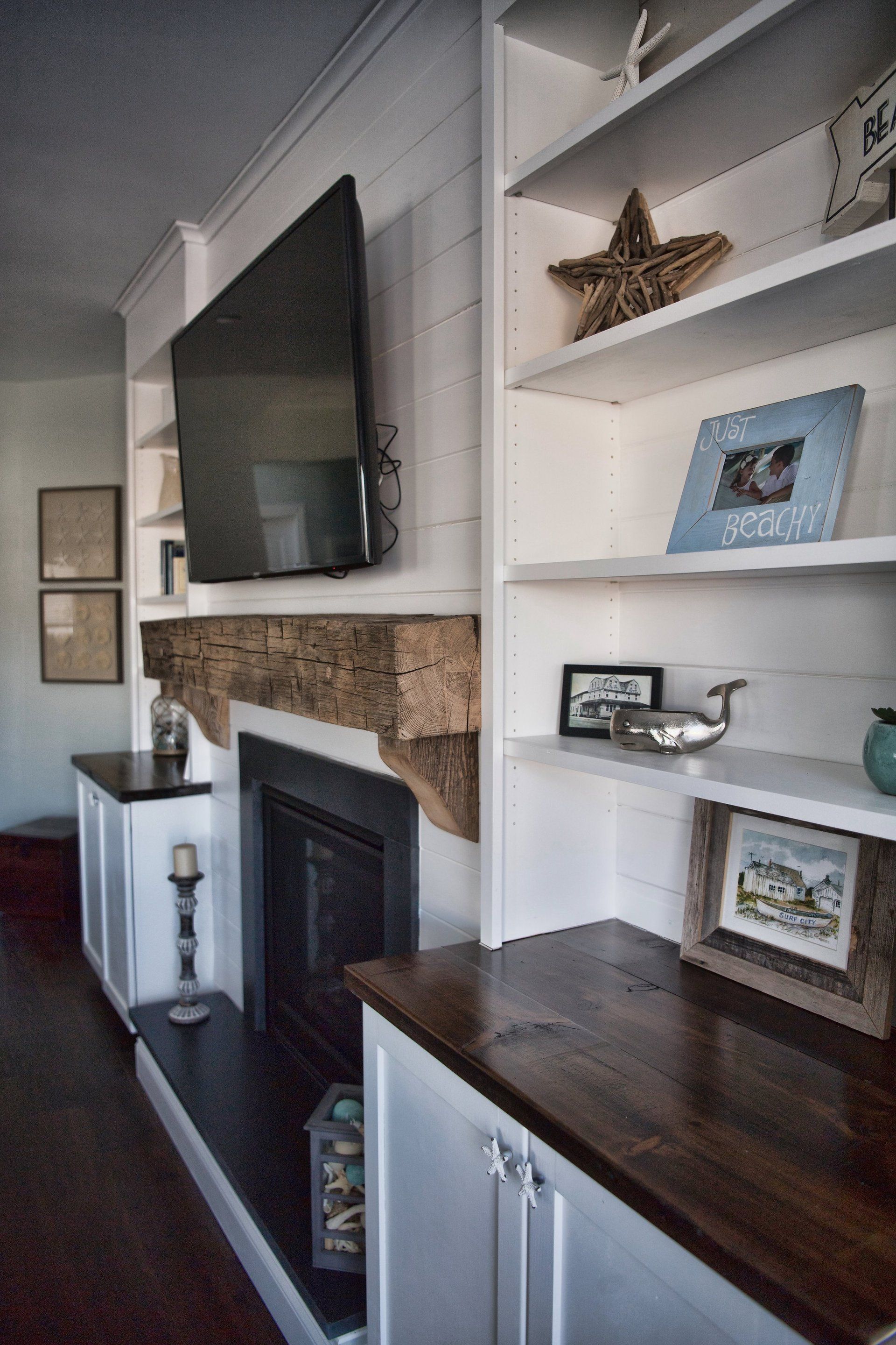 A living room with a fireplace and a flat screen tv